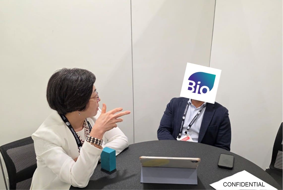 Photo of Yun Kyoung Kang, CEO of GAIA-BT, in a one-on-one meeting at BIO Partnering 2025 with an anonymized attendee.